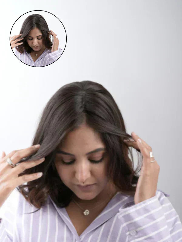A woman with voluminous, natural-looking hair, styled with a hair topper extension made from 100% human remy hair, enhancing her confidence and beauty