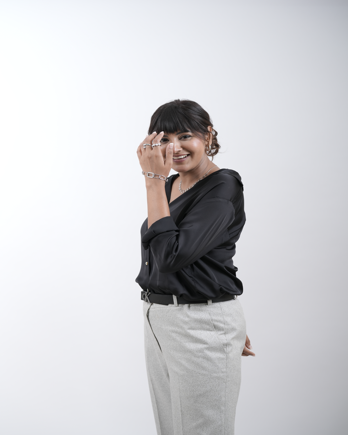 A woman with a stylish Indian front hair cut, featuring soft bangs and voluminous layers, enhanced with Hair Haux extensions for a fuller, natural look.