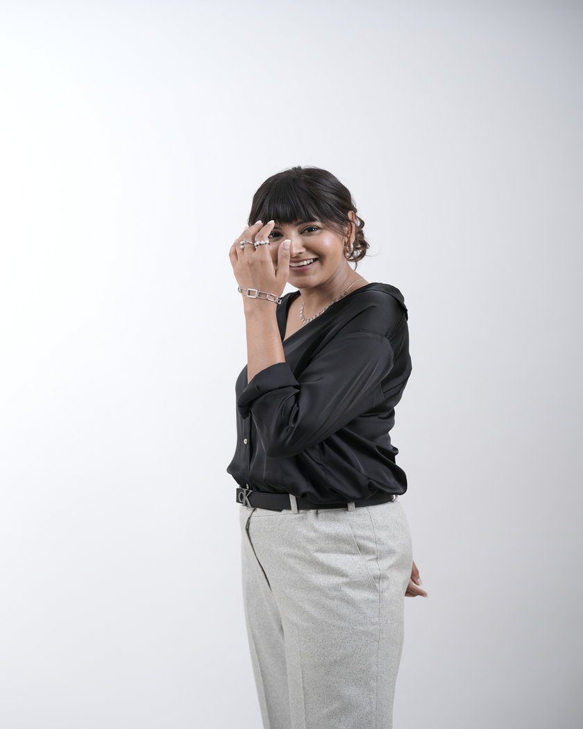 A woman styling her front hair using a curling iron, achieving a sleek and elegant look