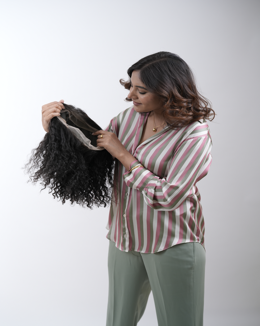 A woman with sleek, frizz-free hair styled using 100% human remy hair extensions from Hair Haux, showcasing smooth, shiny, and perfectly tamed locks