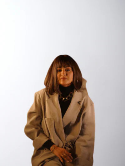 A woman confidently wearing a 100% human Remy hair wig from Hair Haux, showcasing natural shine, volume, and a flawless style