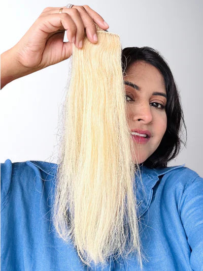 Close-up of silky black hair with vibrant burgundy highlights, showcasing depth, elegance, and a stylish transformation