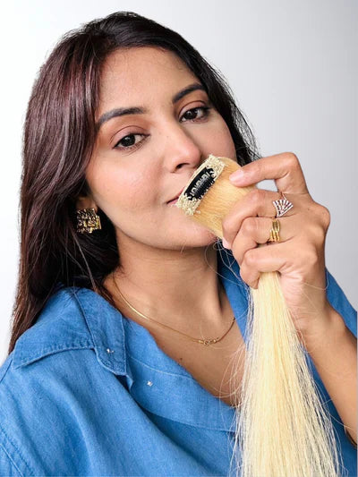 Stylish woman with a burgundy hairstyle, showcasing rich red-purple tones in soft waves, highlighted by elegant lighting to emphasize the hair's shine and luxurious texture