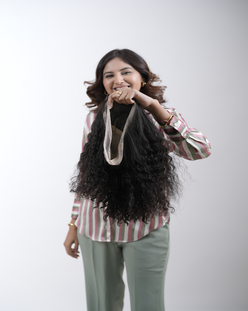 A professional hairstylist transforming a client’s hair in a modern salon, using Hair Haux extensions for a voluminous and stylish look