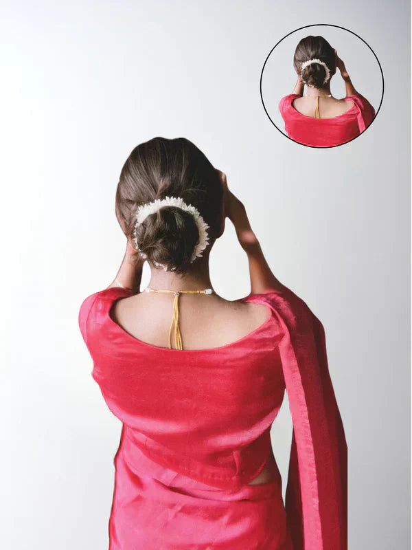 A stylish woman with voluminous hair wearing Hair Haux extensions, accessorizing with trendy jewelry, and confidently posing in a chic outfit